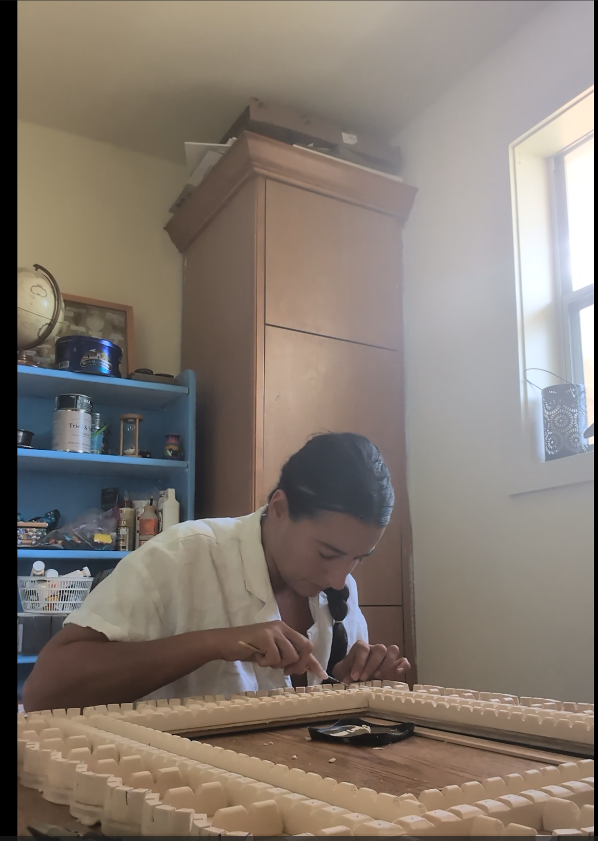 Refining the carved details in Ulviya Bemman's mirror-making process