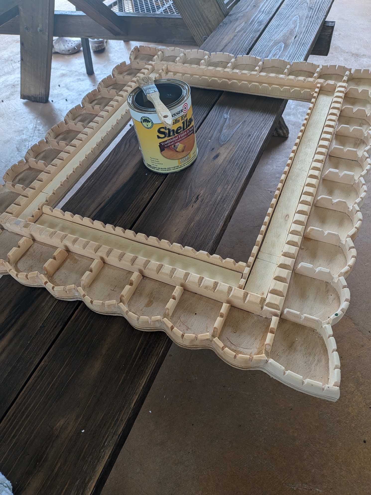 Smoothing and sealing the wood in Ulviya Bemman's mirror-making process