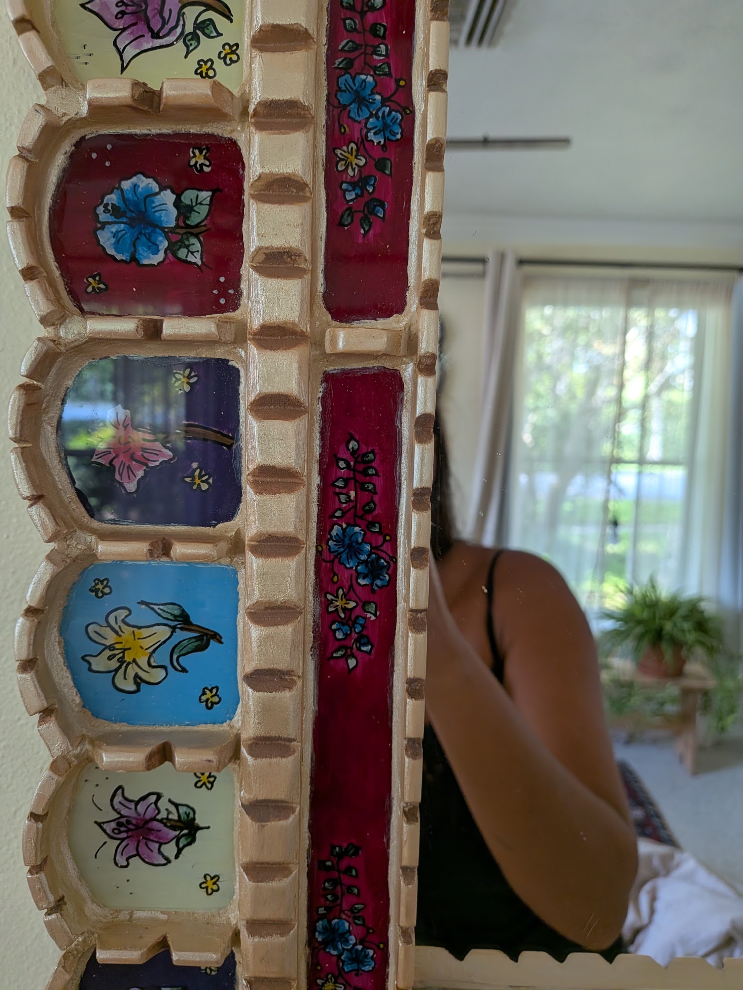 Close-up of Winter Garden's hand-painted flowers and carved gold frame